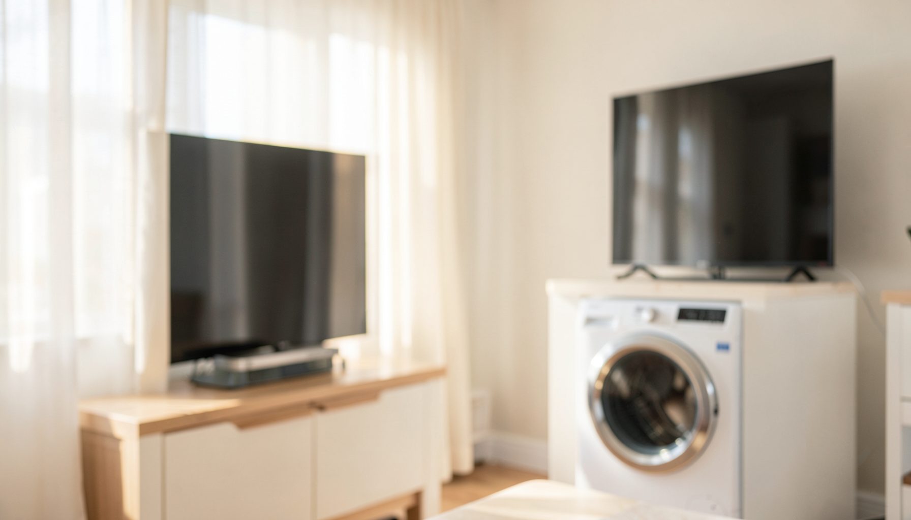A clean, bright home interior with a modern television and washing machine in soft focus, warm daylight streaming through the room